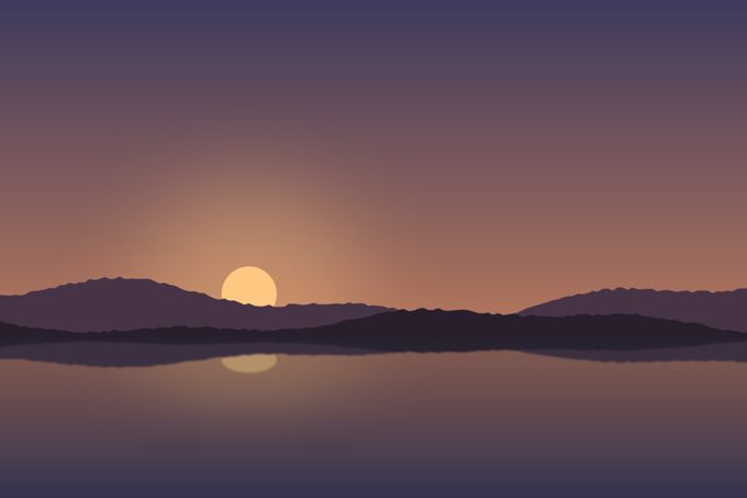 A calm lake under an orange sky